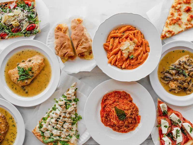 A spread of Cestra's pasta, chicken, salads, wraps and pizza