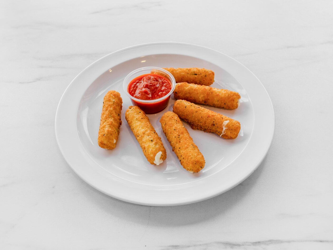 Golden mozzarella sticks served with marinara sauce